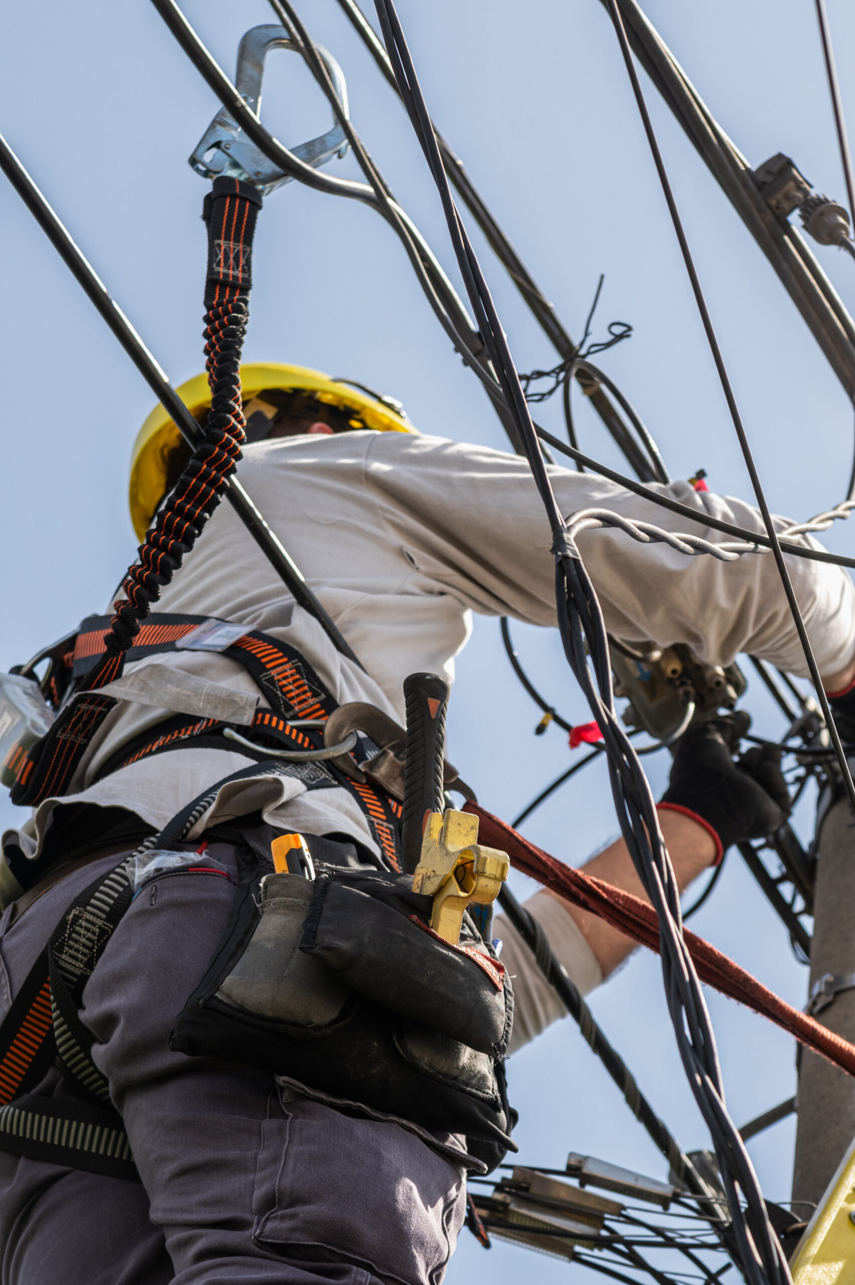 unrecognizable person installer of aerial technology cable and internet with security